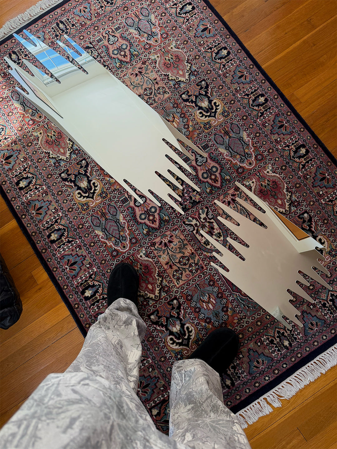 Two Mirror 001 spiked-edge mirrors laid flat, unmounted, showing the full jagged silhouette