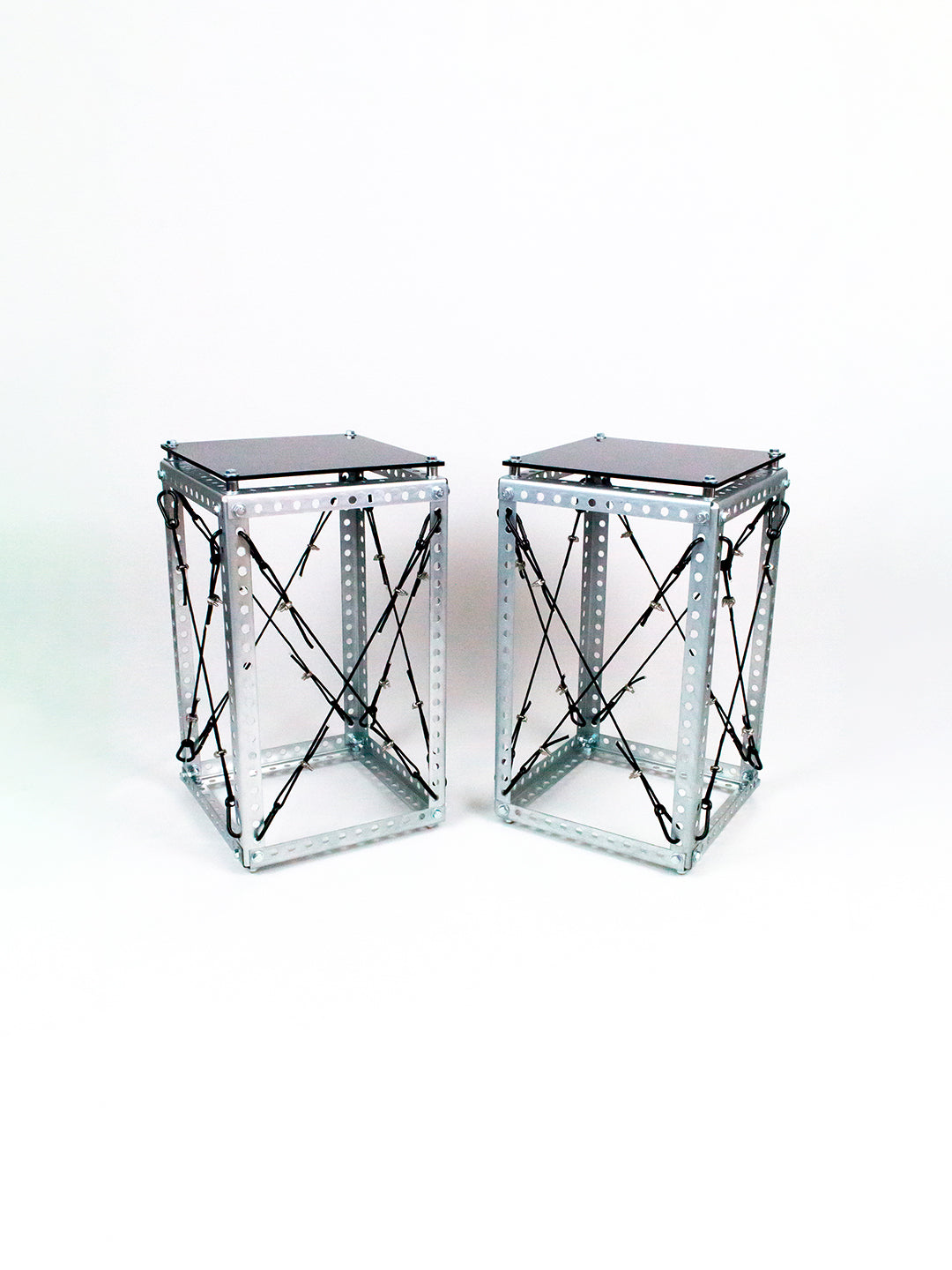 Pair of Side Table Set DP-001 tables, Diagrid steel frames with black tops, shown together on a white background.